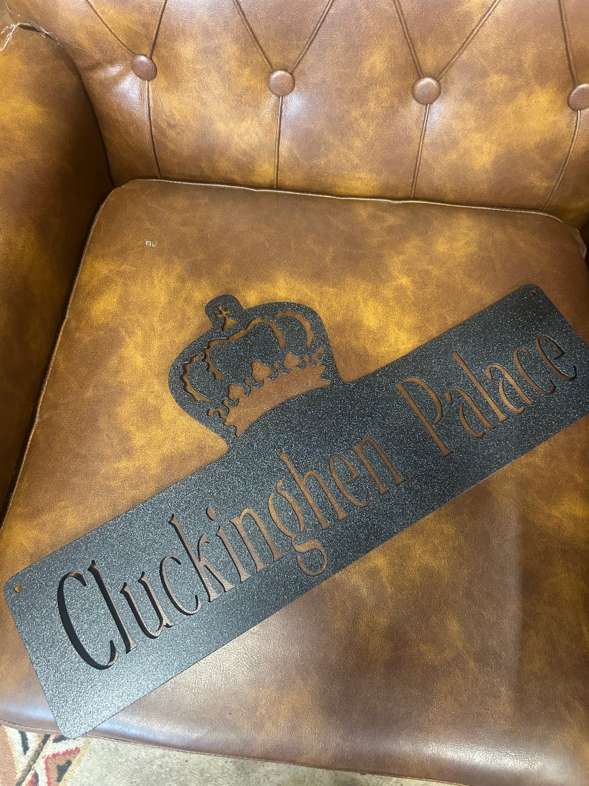 Brown leather chair with a 'Cuckfield' branded mat on it