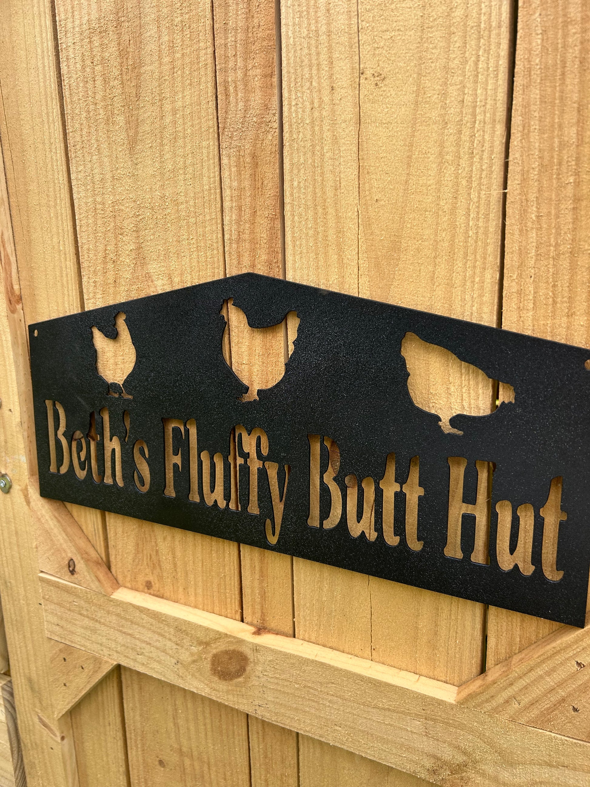 coop with sign with text and hen illustrations on a wooden background