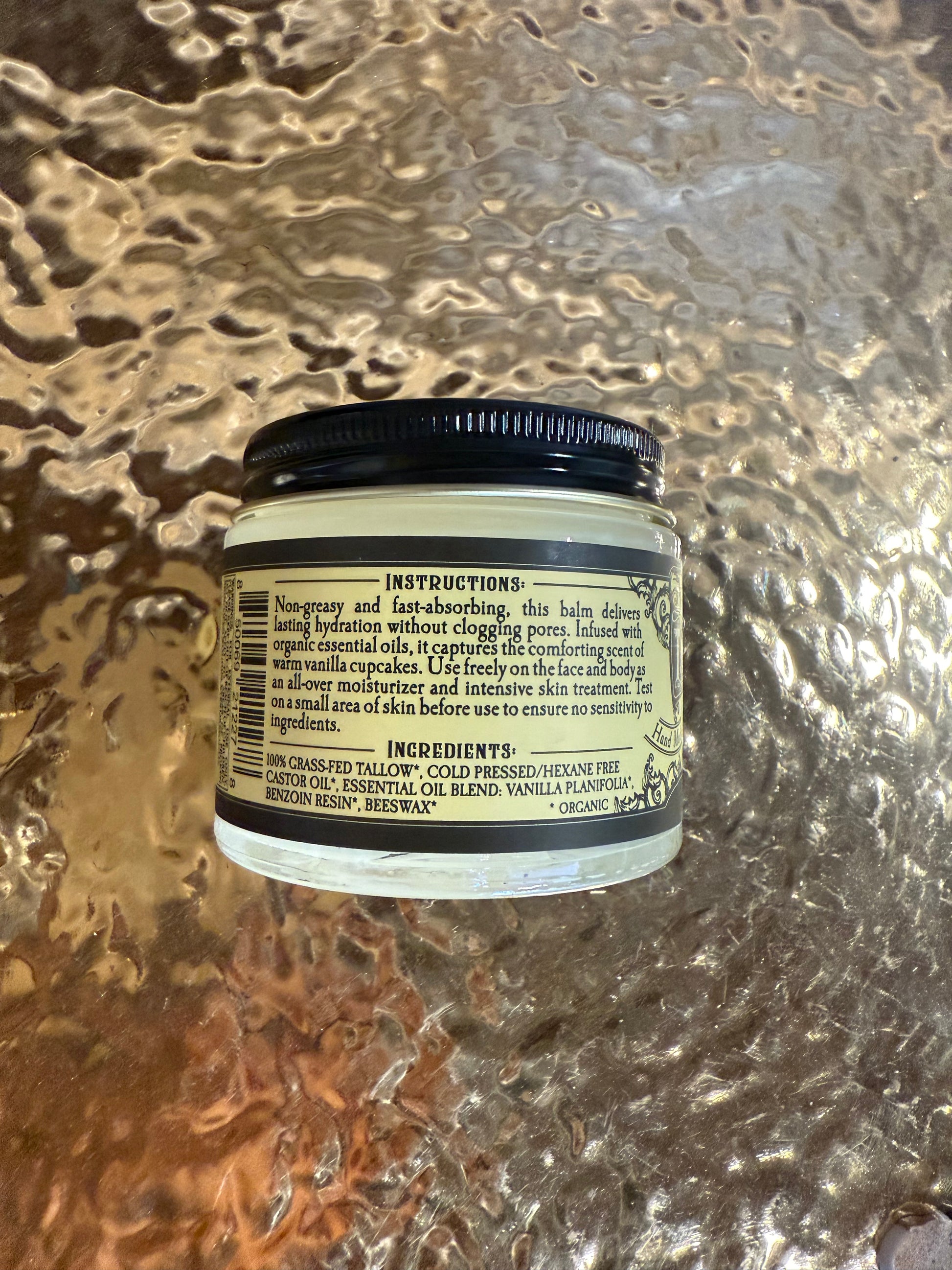 Jar with a label on a textured metallic surface