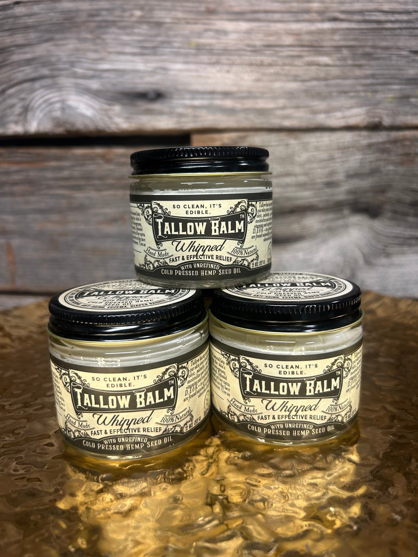 jars of Tallow Balm on a wooden surface