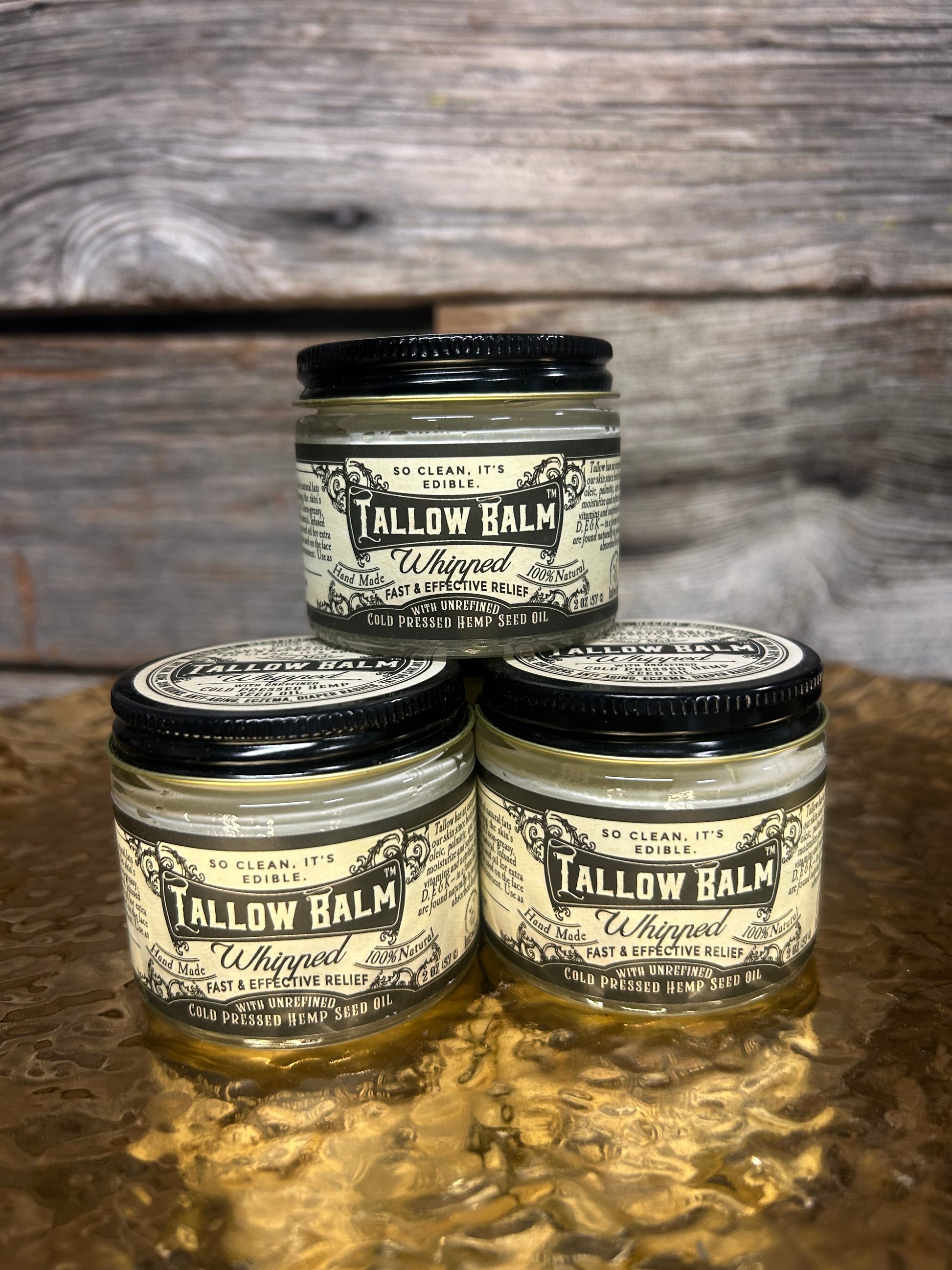 jars of Tallow Balm on a wooden surface
